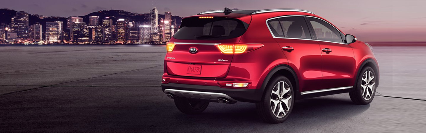 Rear view of a red Sportage parked by the city