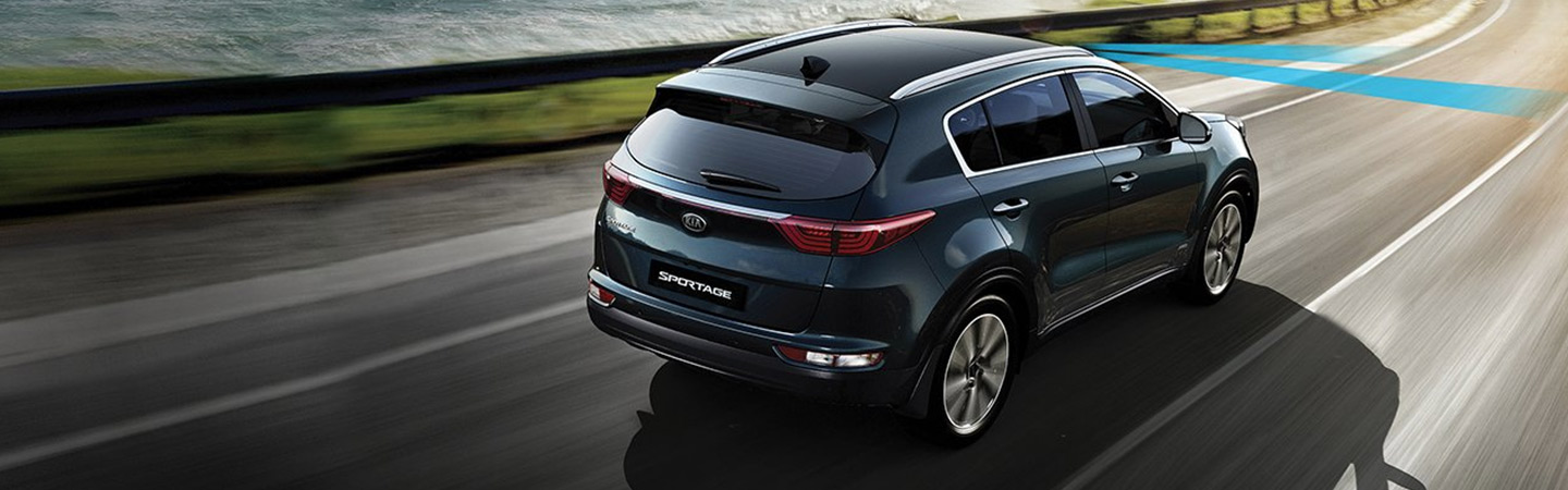 Blue Kia Sportage in motion