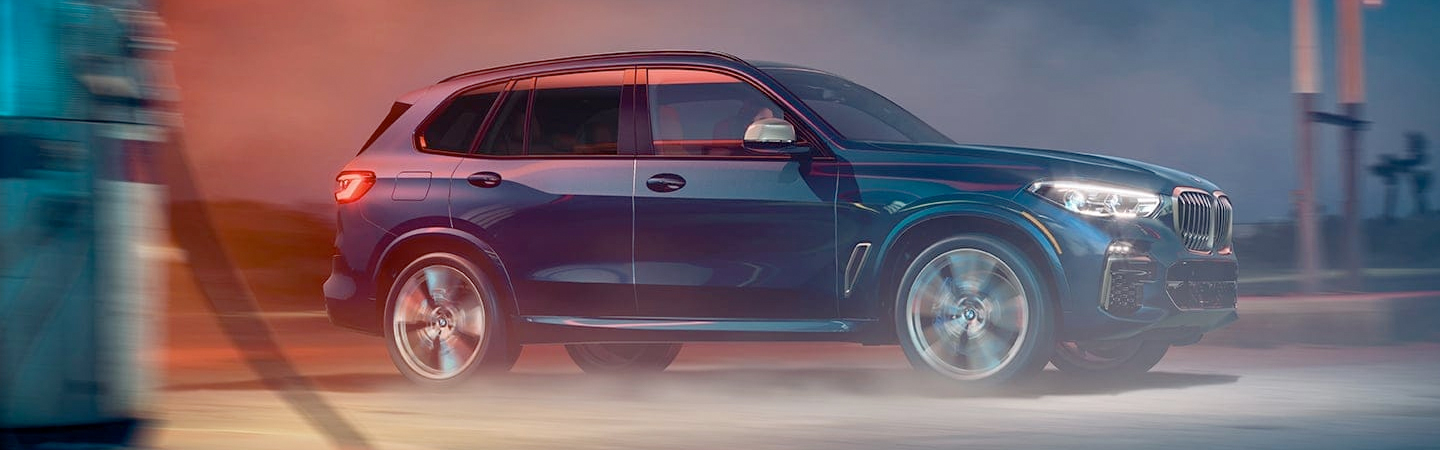 Blue 2021 BMW X5 Leaving Gas Station