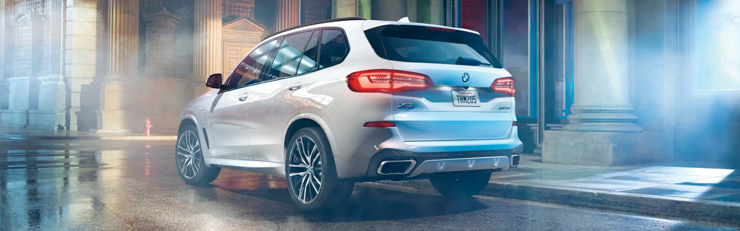 Rear View of White 2021 BMW X5 Parked on Street