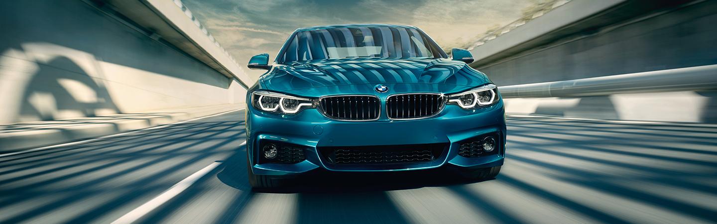 Front view of a Blue 2020 BMW 4 Series in motion 
