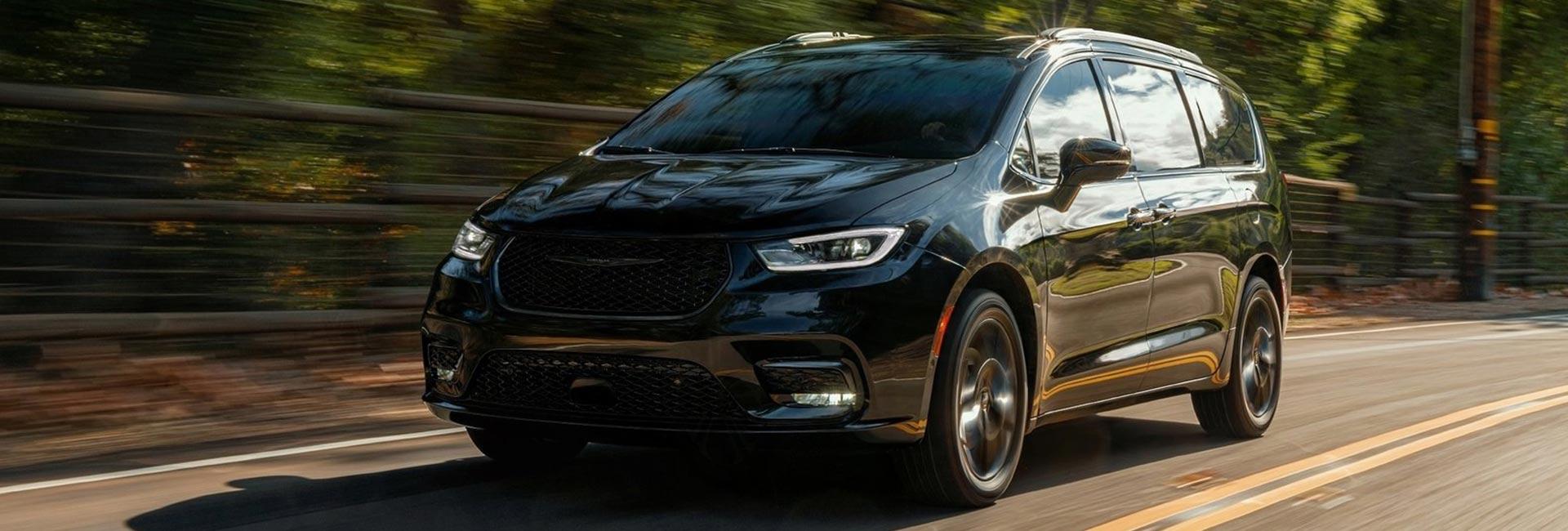 EBlack 2021 Pacifica in motion through a forest road