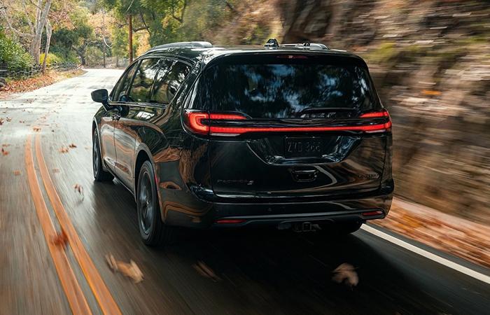 2021 Black Pacifica rear view in motion through a mountain road