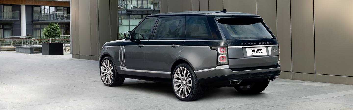 White Range Rover driving into a river