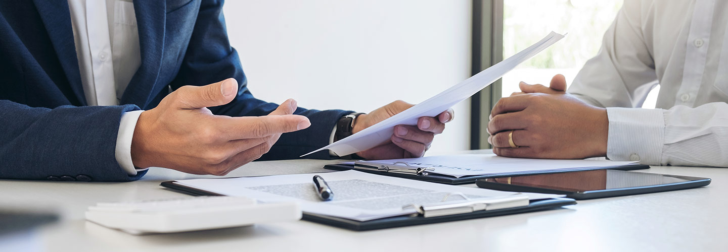 Two people looking at financing documents