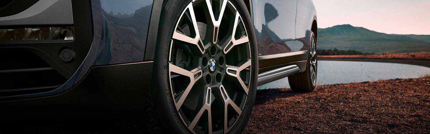 Close up of 2021 BMW X1 Wheel Next to Mountain Lake