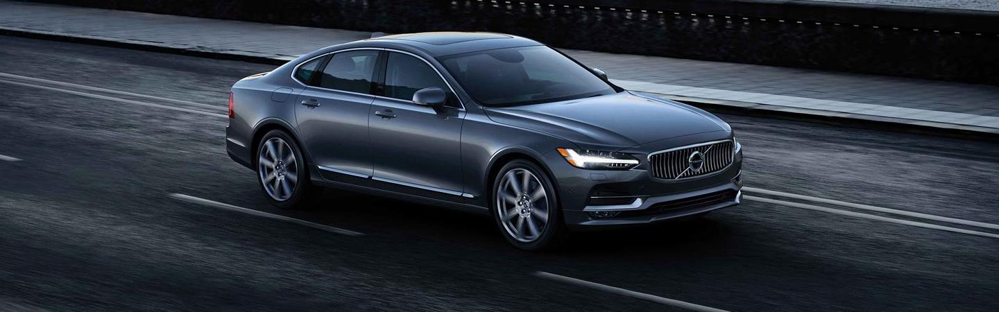 Passenger side view of silver S90 in motion