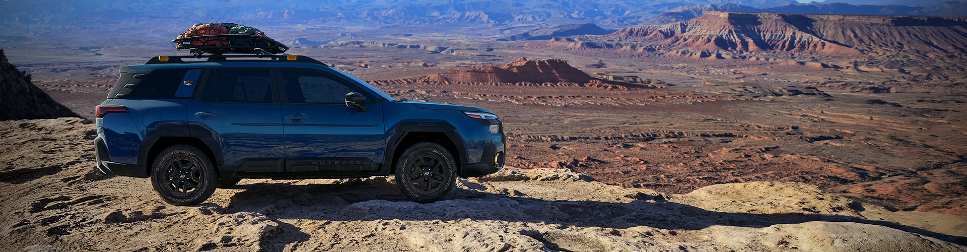 Blue Subaru Outback Wilderness in scenic park