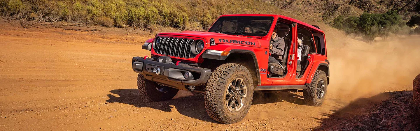 2025 Jeep Wrangler Rubicon driving on a dirt road