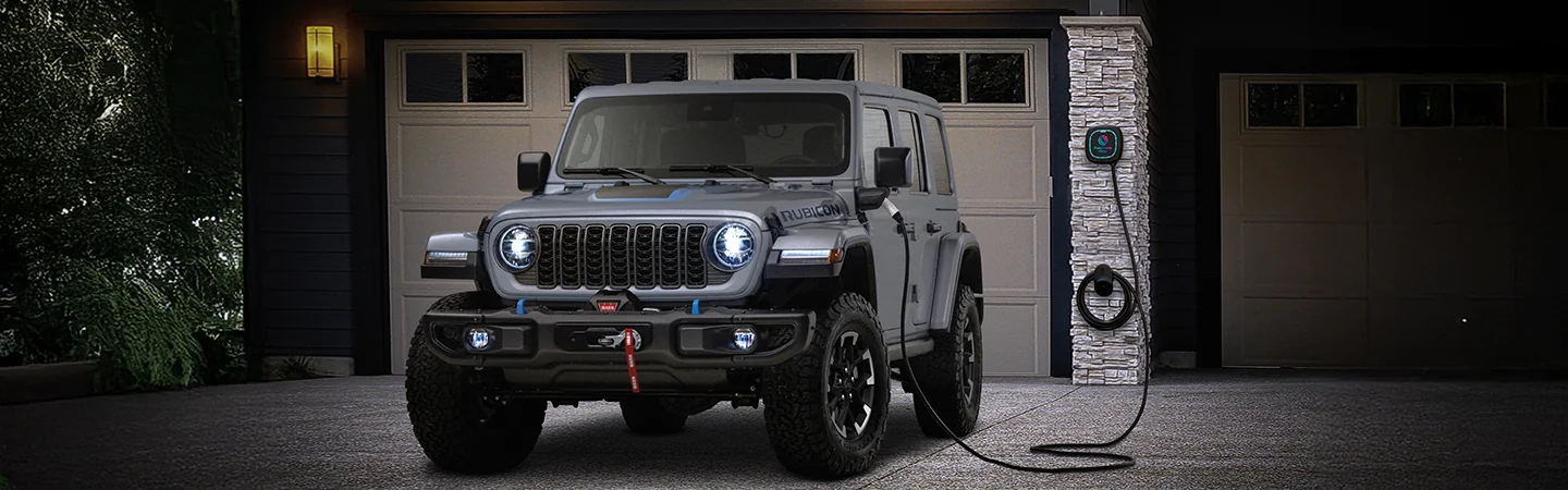 2025 Rubicon parked in front of a house plugged in to a power source