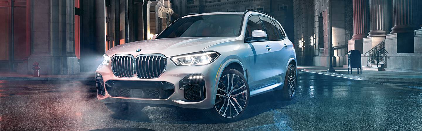 White 2020 BMW X5 turning on a road