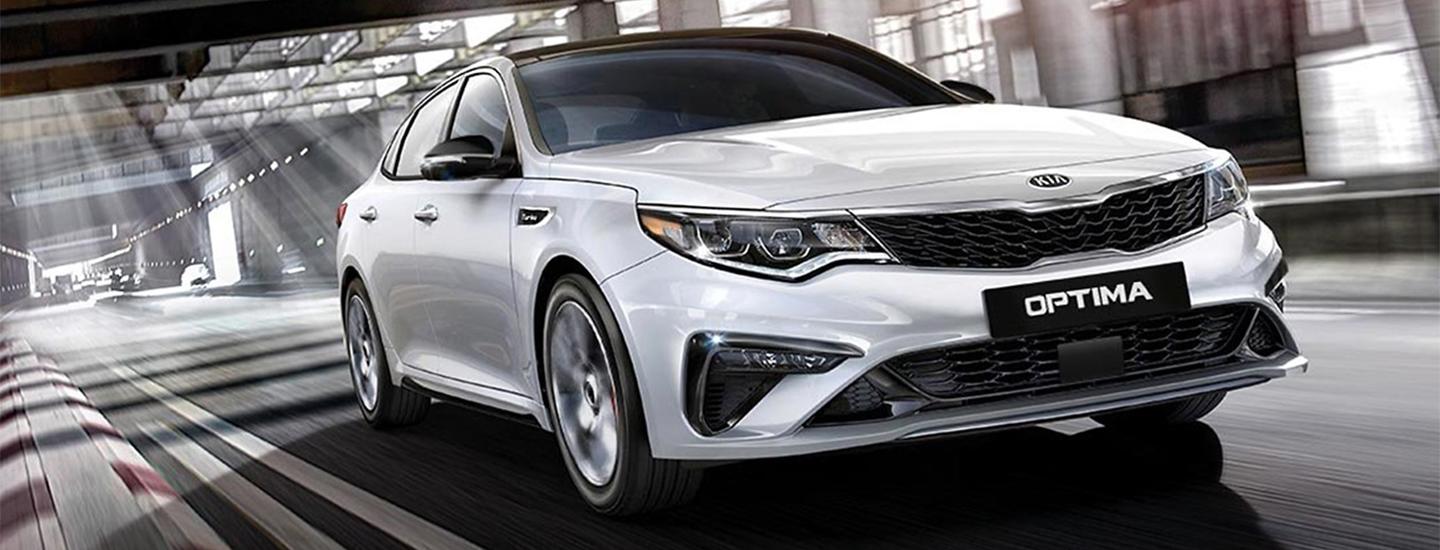 Silver Kia Optima in motion in a tunnel