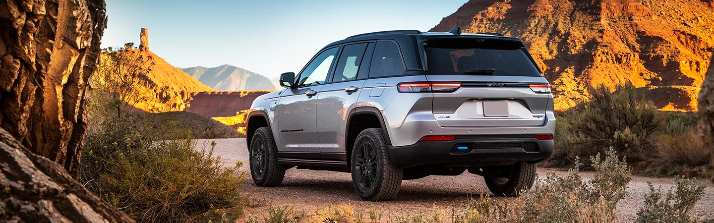 2025 Jeep Grand Cherokee driving down a gravel road