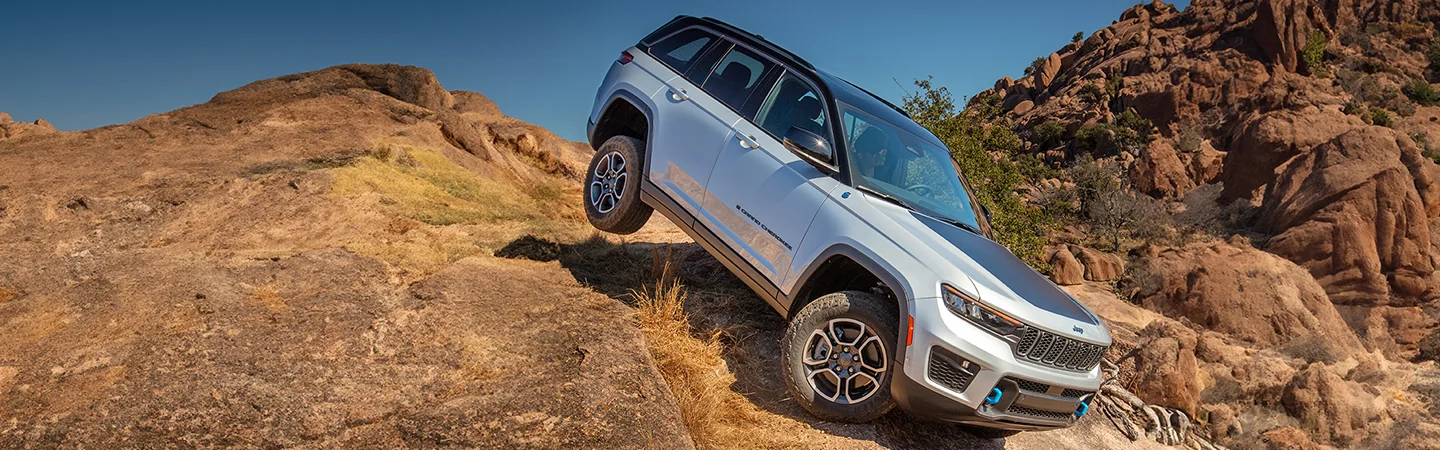 2025 Jeep Grand Cherokee driving down a mountain