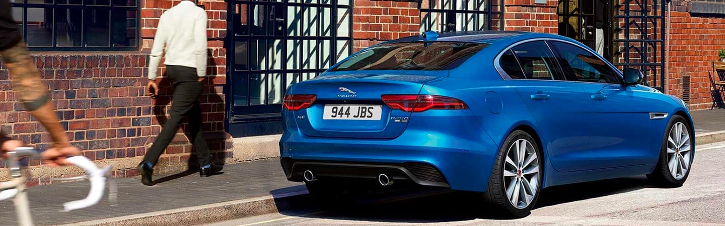 Rear view of blue XE parked