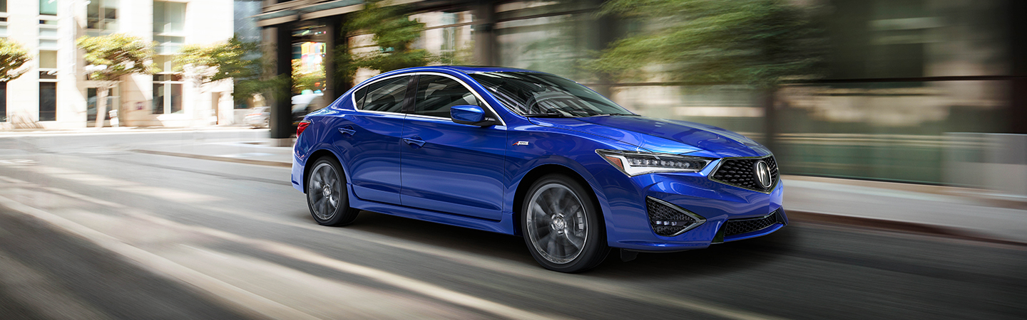 Blue 2021 Acura ILX driving on a city street