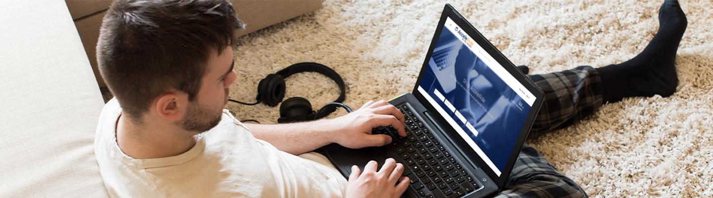 Man sitting on floor with a laptop