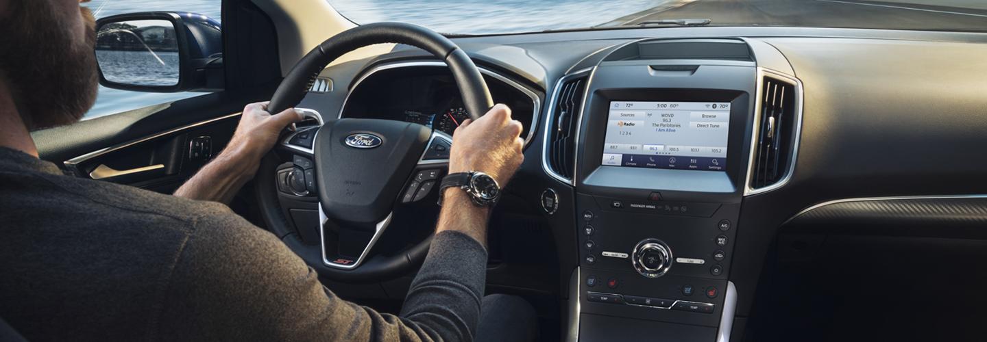 steering wheel and entertainment center inside the 2020 Ford Edge