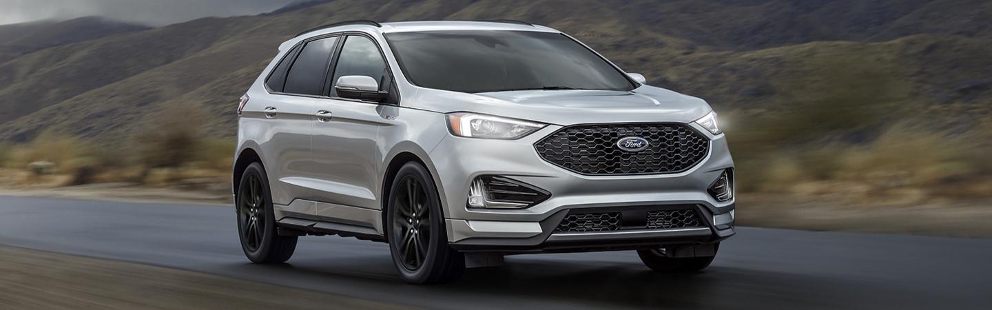 Front view of a silver 2020 Ford Edge in motion