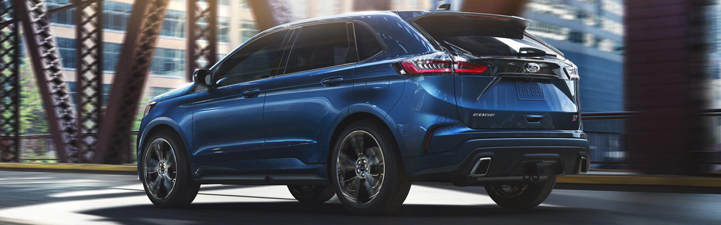 Side rear view of a blue 2020 Ford Edge