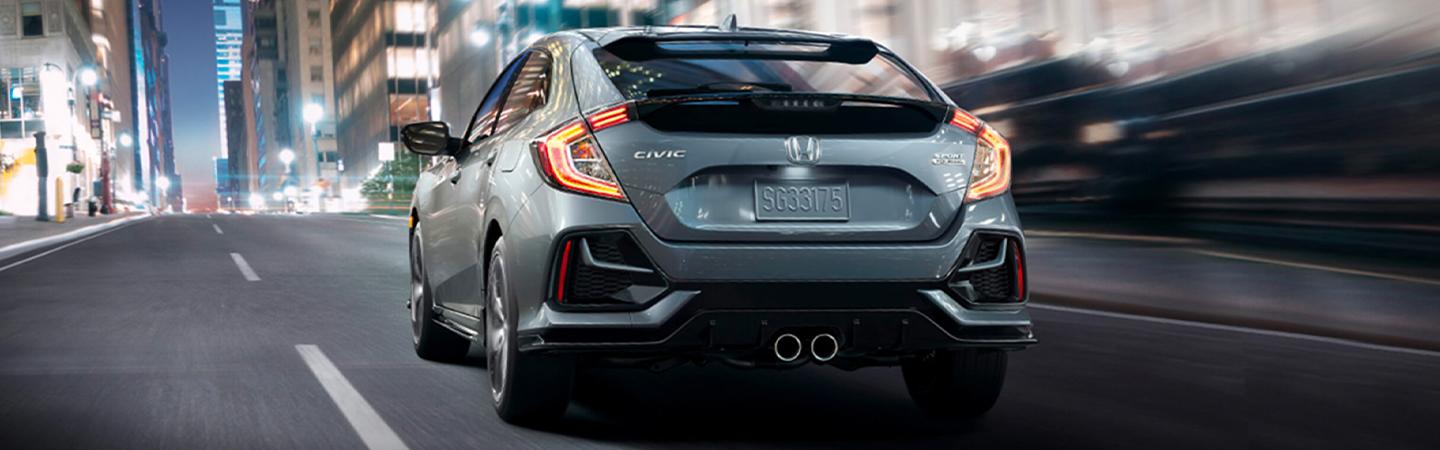 Grey 2021 Honda Civic Hatchback in motion rear view angle