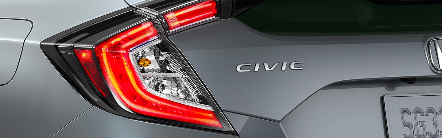 Grey 2021 Honda Civic Hatchback rear view angle with light on