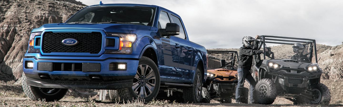 Front view of a blue 2020 Ford F-150 off roading