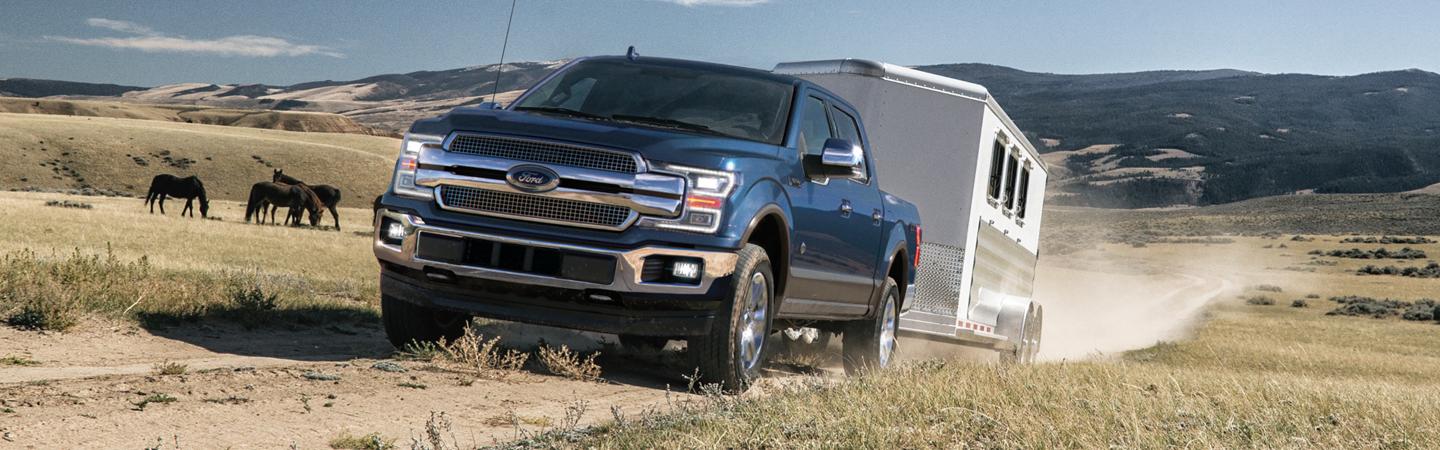 Blue 2020 Ford F-150 towing a trailer