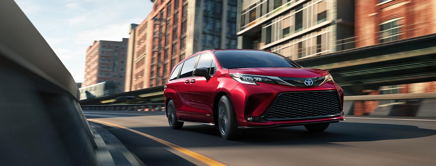 Red 2020 Toyota Sienna Driving on City Highway