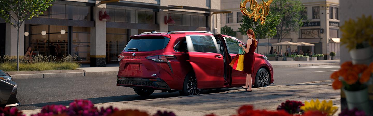 Red 2020 Toyota Sienna Parked on Street Woman Standing by Open Doors