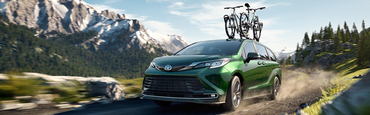 Green 2020 Toyota Sienna Driving on Trail with Mountain Bike On Roof