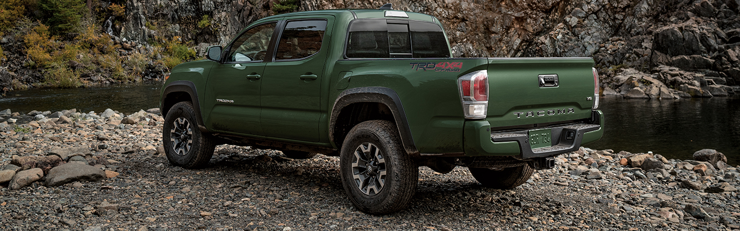 Green 2021 Toyota Tacoma parked on river bank