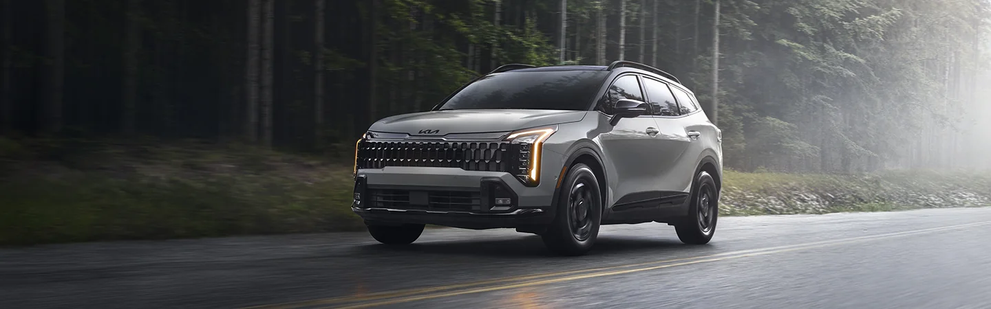 2026 Kia Sportage driving on a foggy country road
