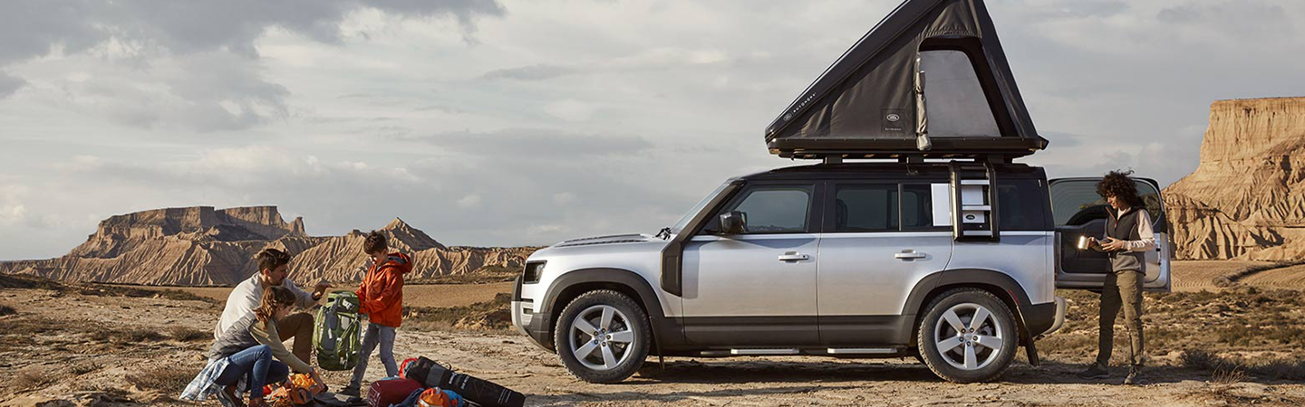 2024 Land Rover Defenders white sideview 