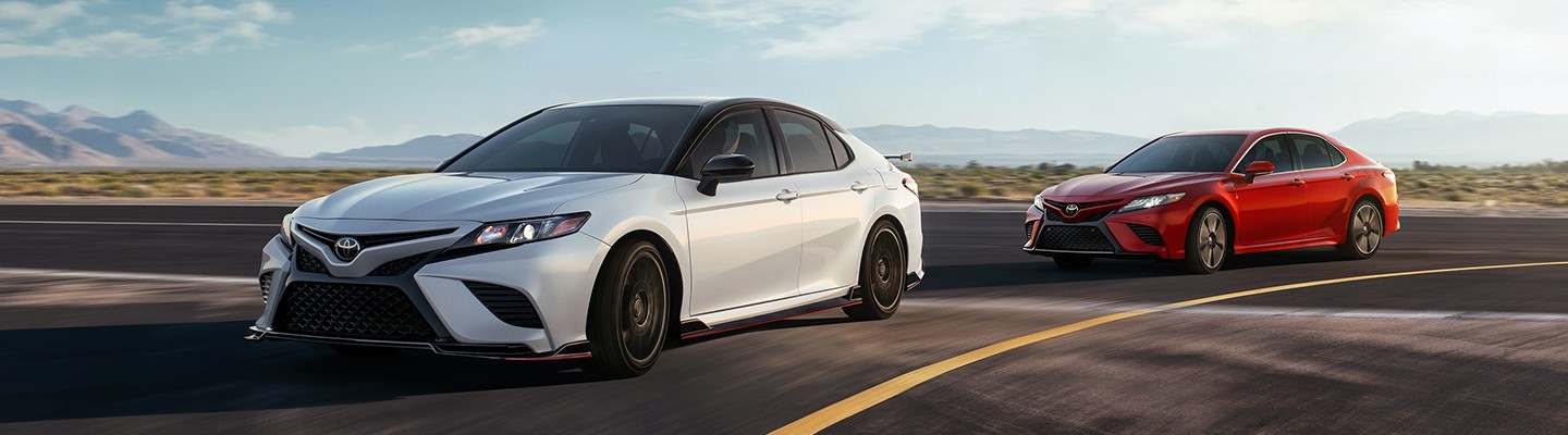 Two 2020 Toyota Camry vehicles in motion