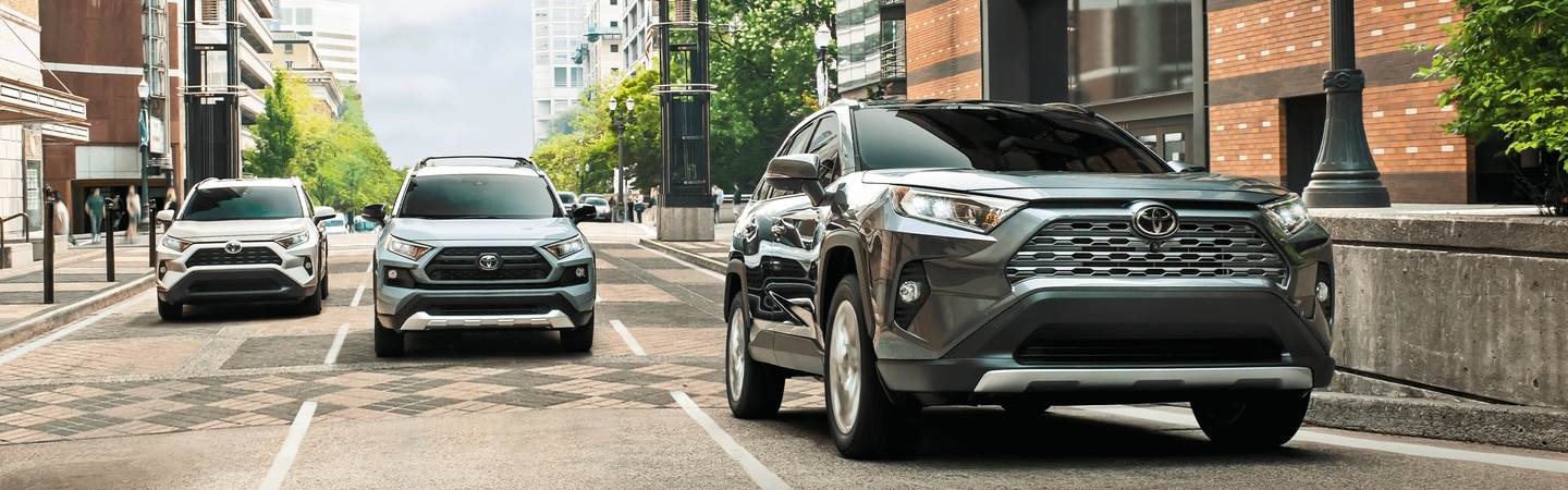 Three 2020 Toyota RAV4 vehicles driving on the city street
