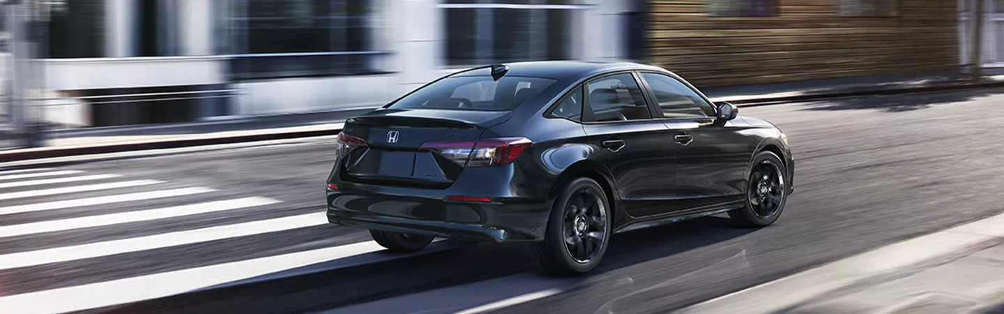 Rear view of the 2026 Honda Civic driving through the city