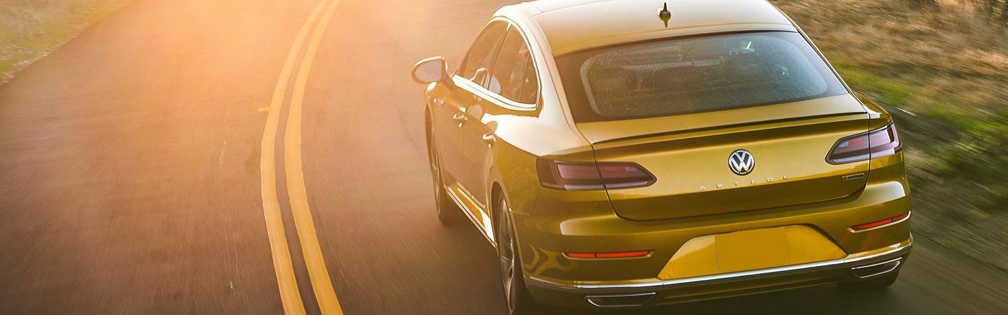 Rear view of the 2019 Volkswagen Arteon driving in the sun
